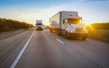 semi tractor trailer driving on the highway in the evening semi tractor trailer driving on the highway in the evening
