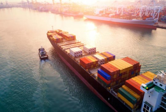 Ship for container with working crane bridge in shipyard for Logistic Import Export background